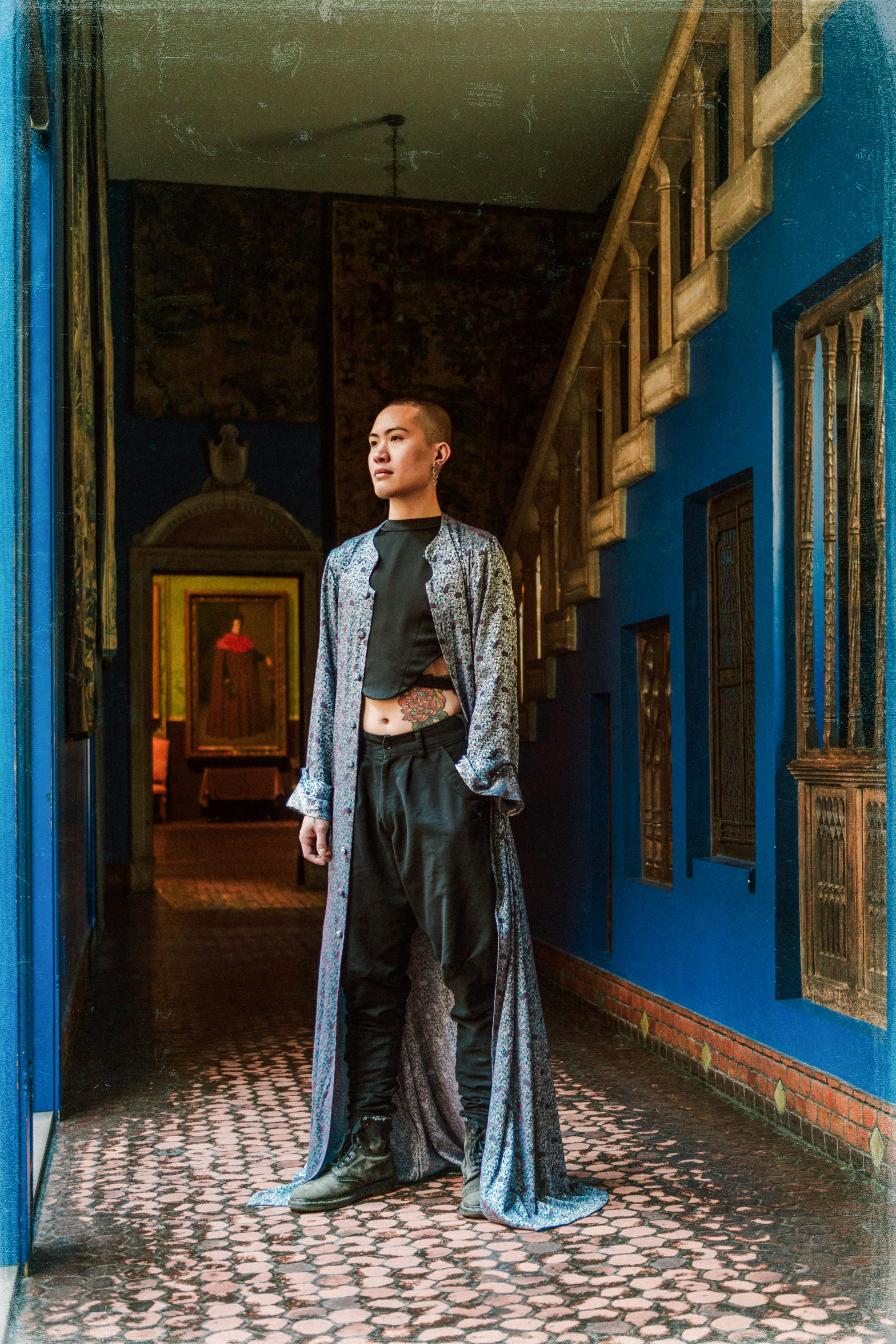 Photo of Aiden in blue outfit in hallway with blue walls