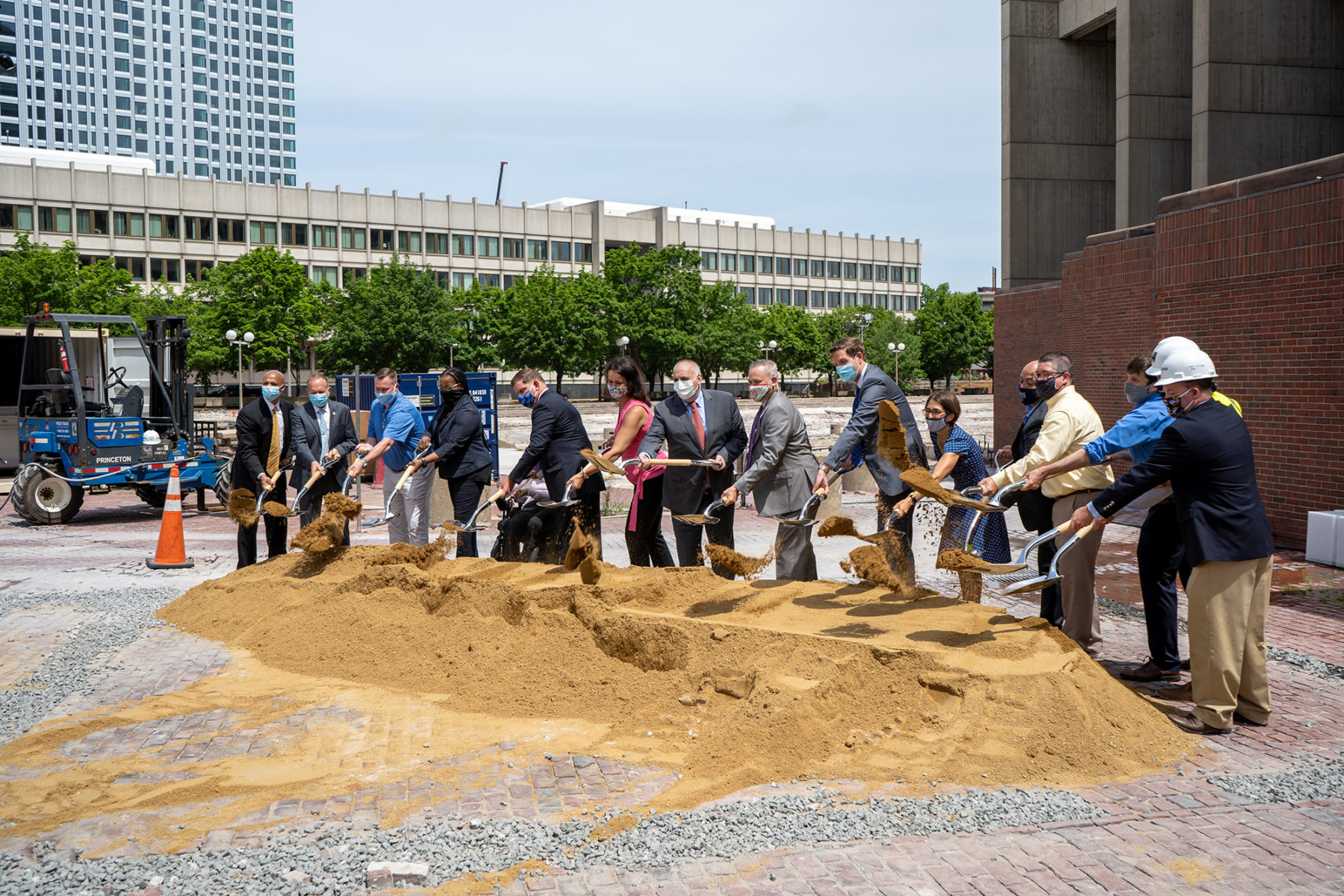 a group of people with shovels at a groundbreaking ceremony