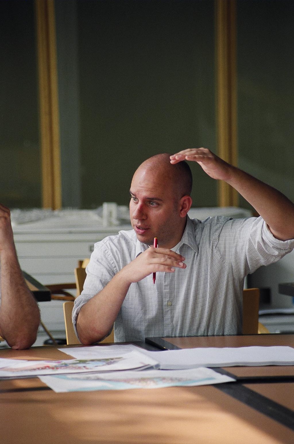 A photo of Grove talking to a colleague during a worksession
