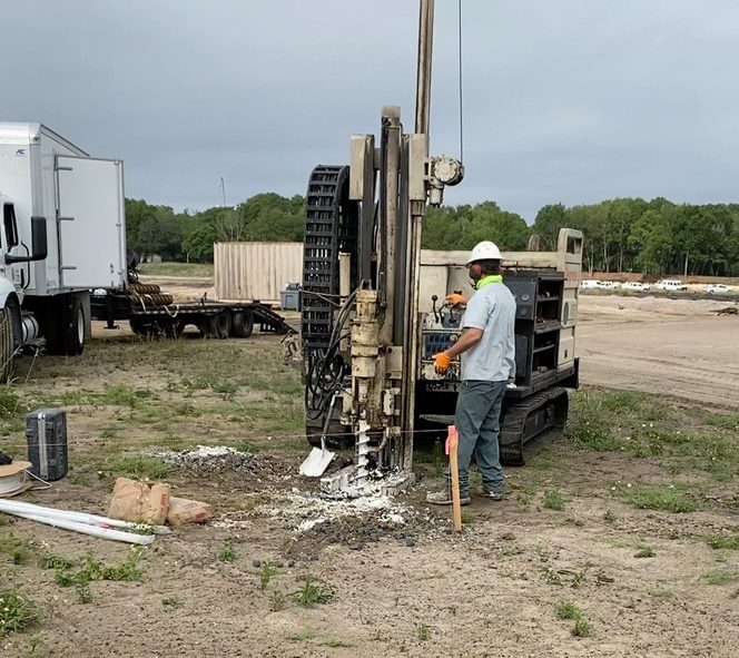 a construction crew drilling into the ground