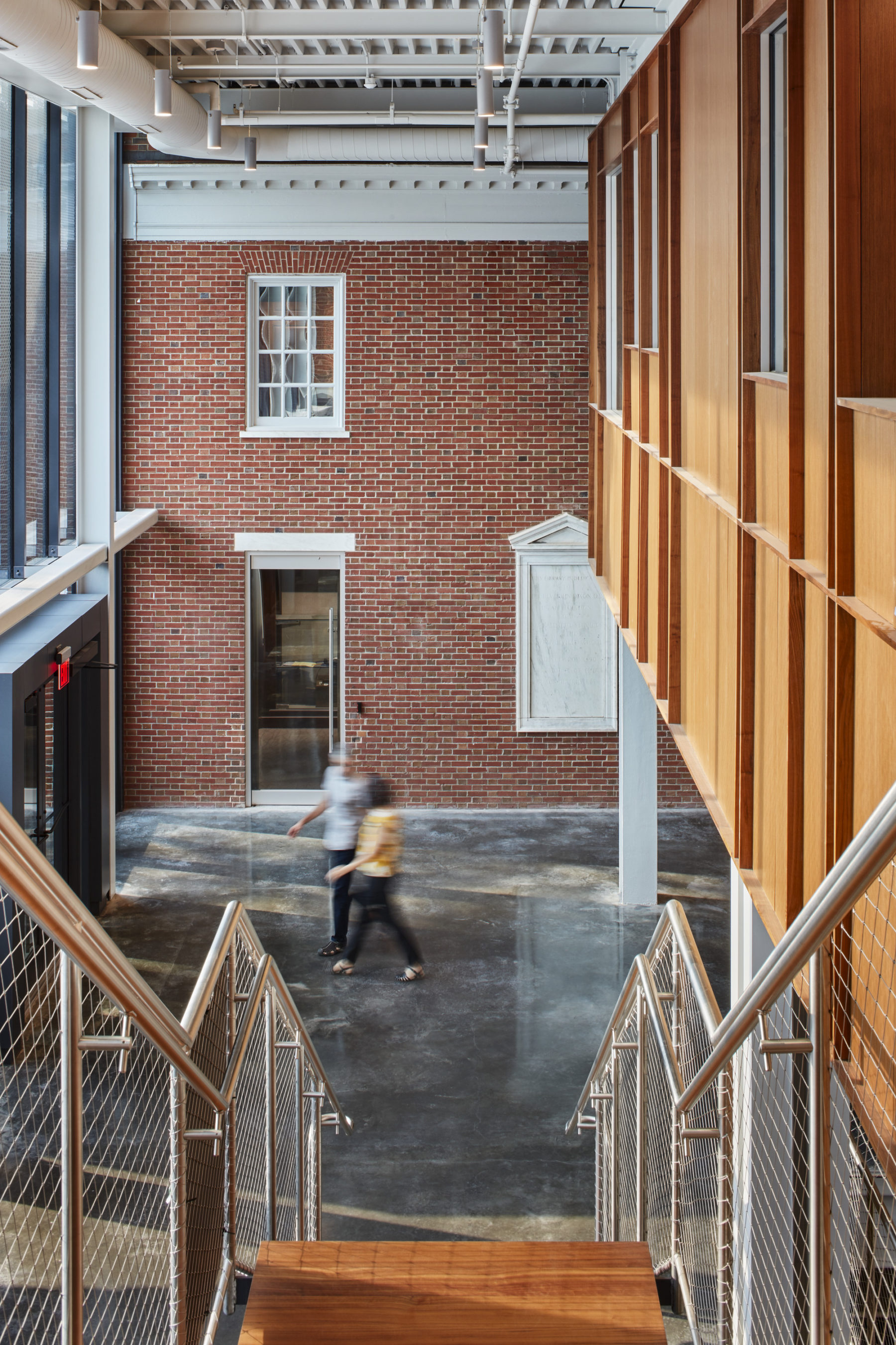 Interior photo looking down the stairs towards a brick building