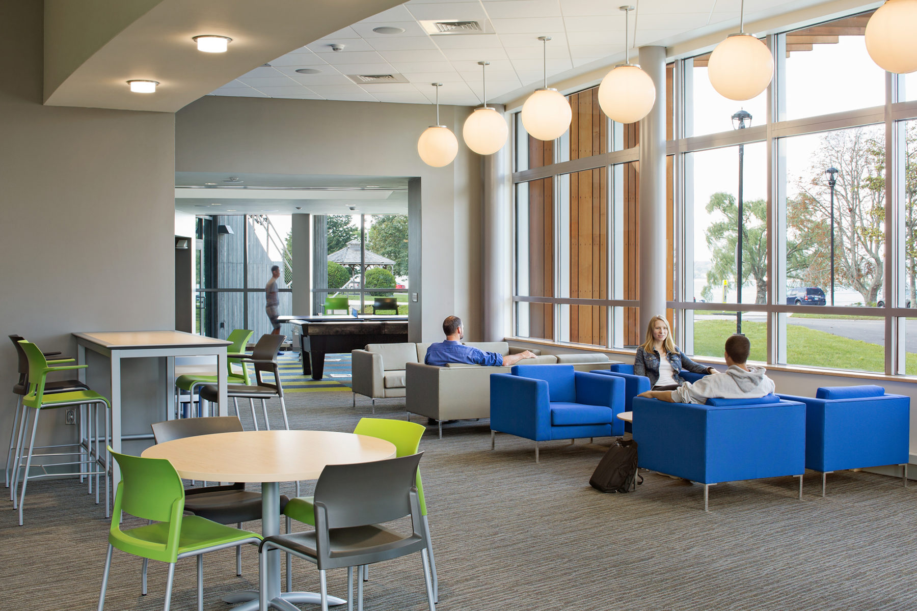 Interior photo of students sitting in lounge chairs