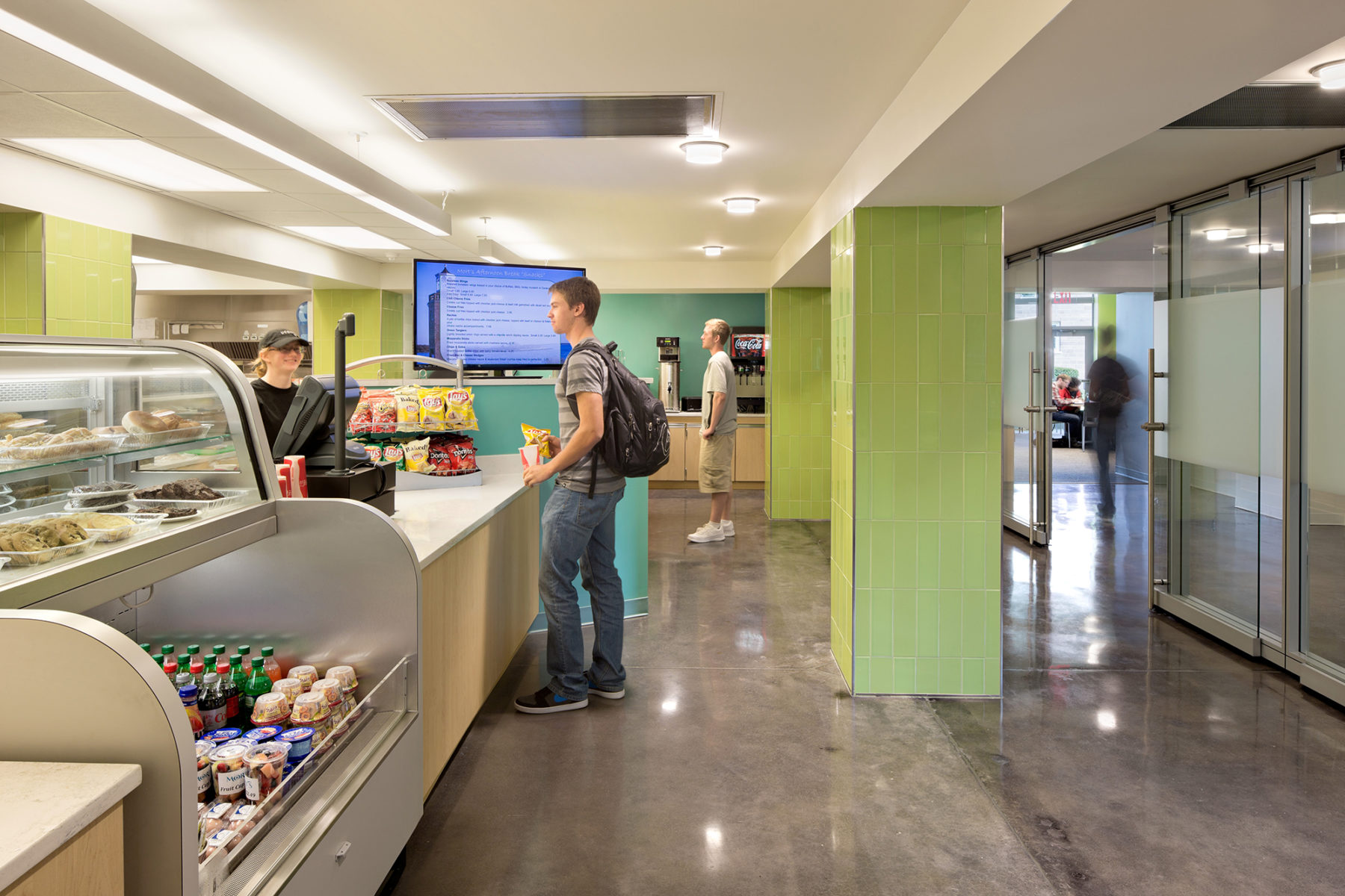 Interior photo of male student buying snacks at a counter