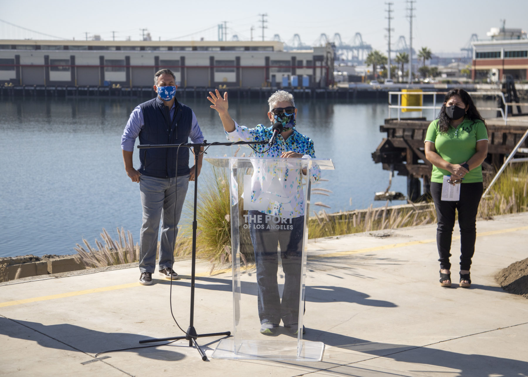 Woman speaking at podium in front of the Port