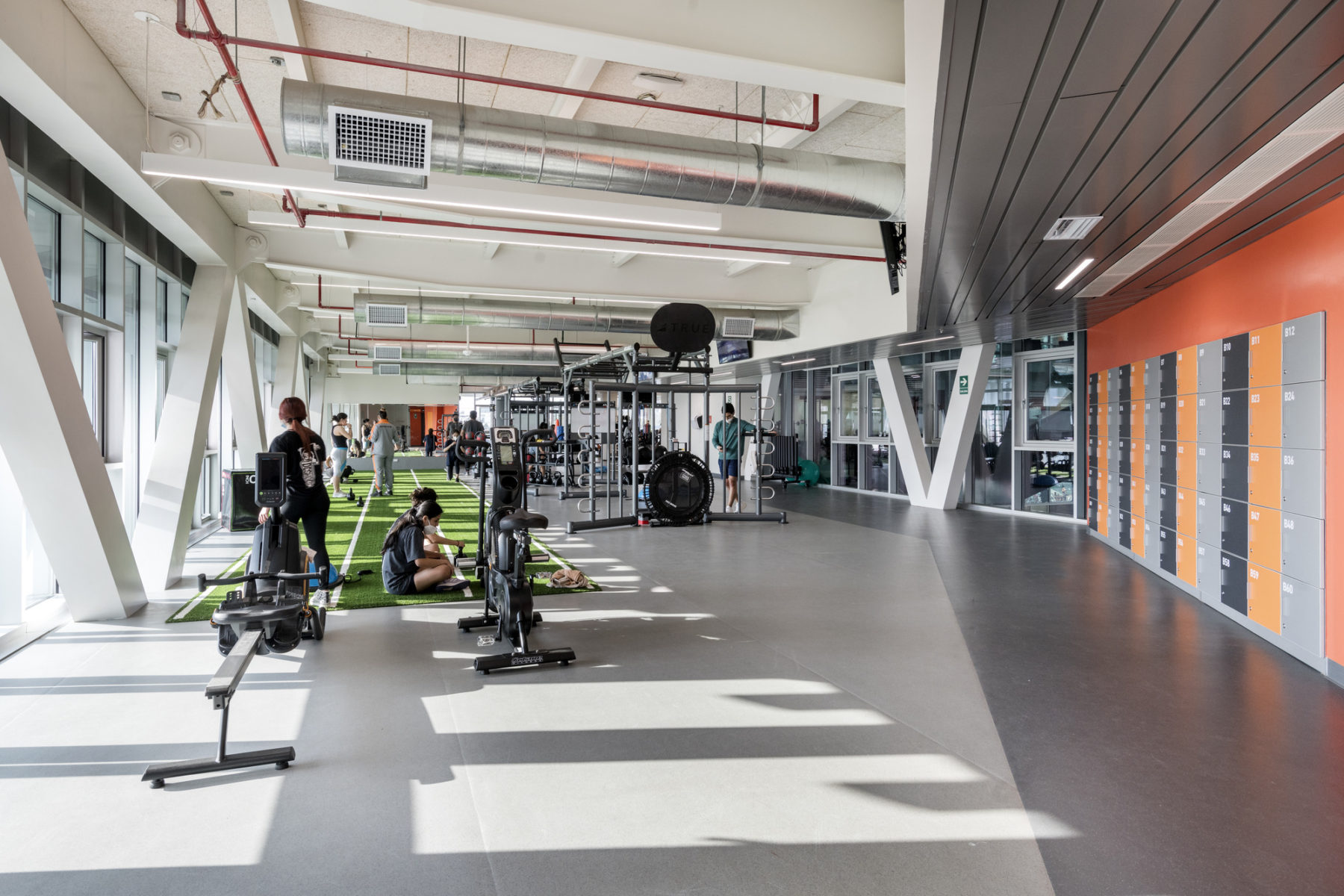 interior photo of circuit training area. a pair of students is working out on the left side of the image.