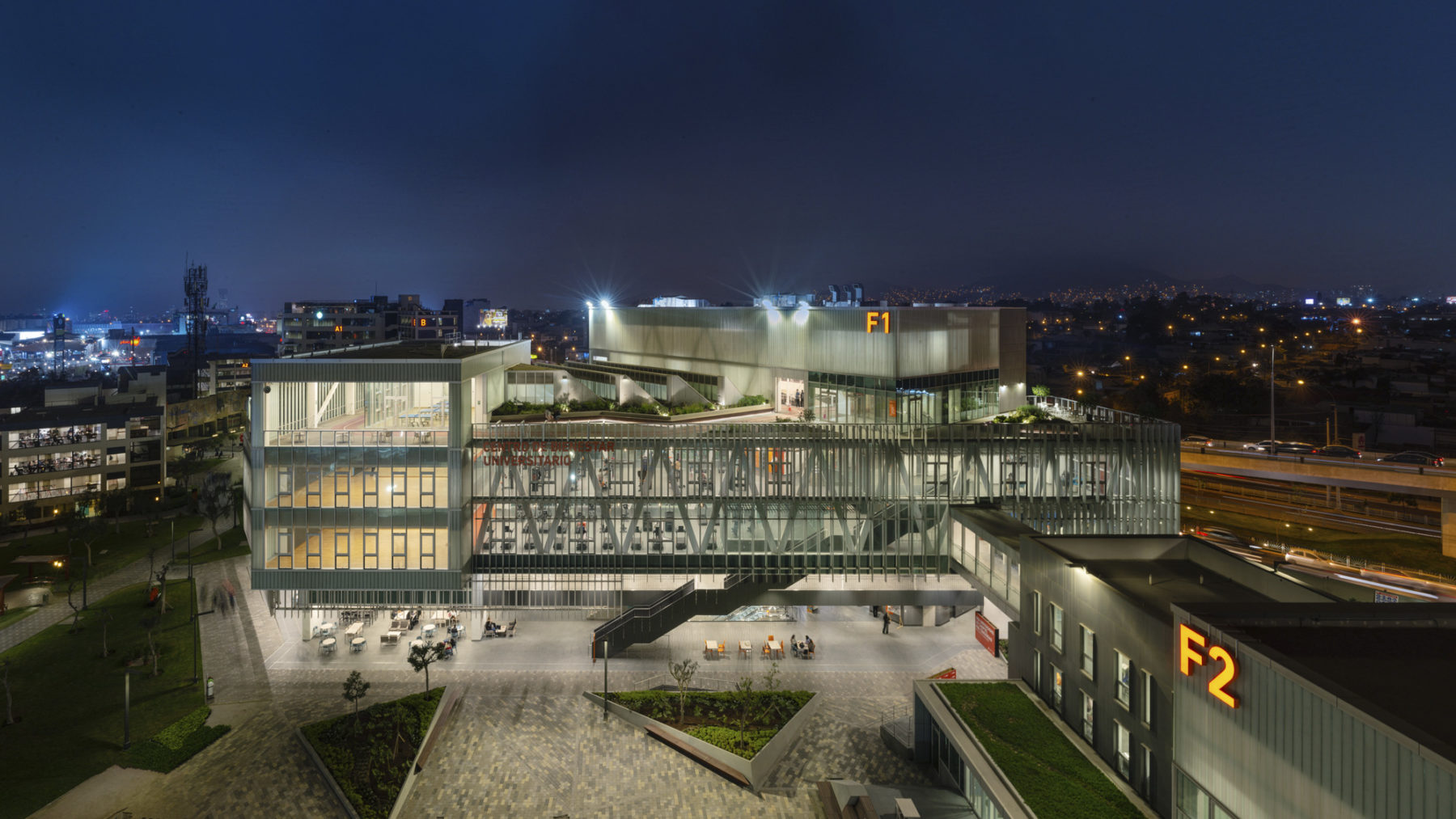 aerial photo of building exterior at night. interior of building is illuminated