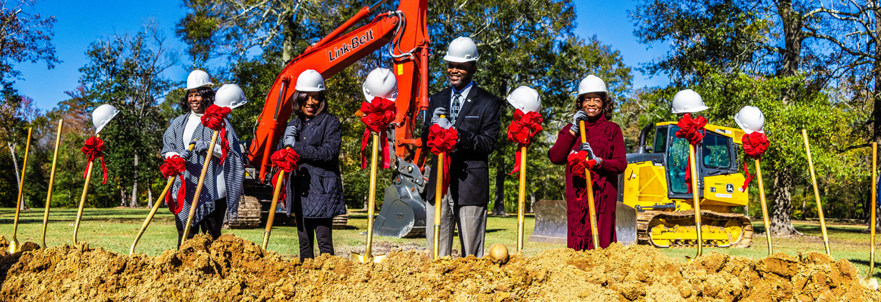 A group of city officials holding shovels at a groundbreaking ceremony