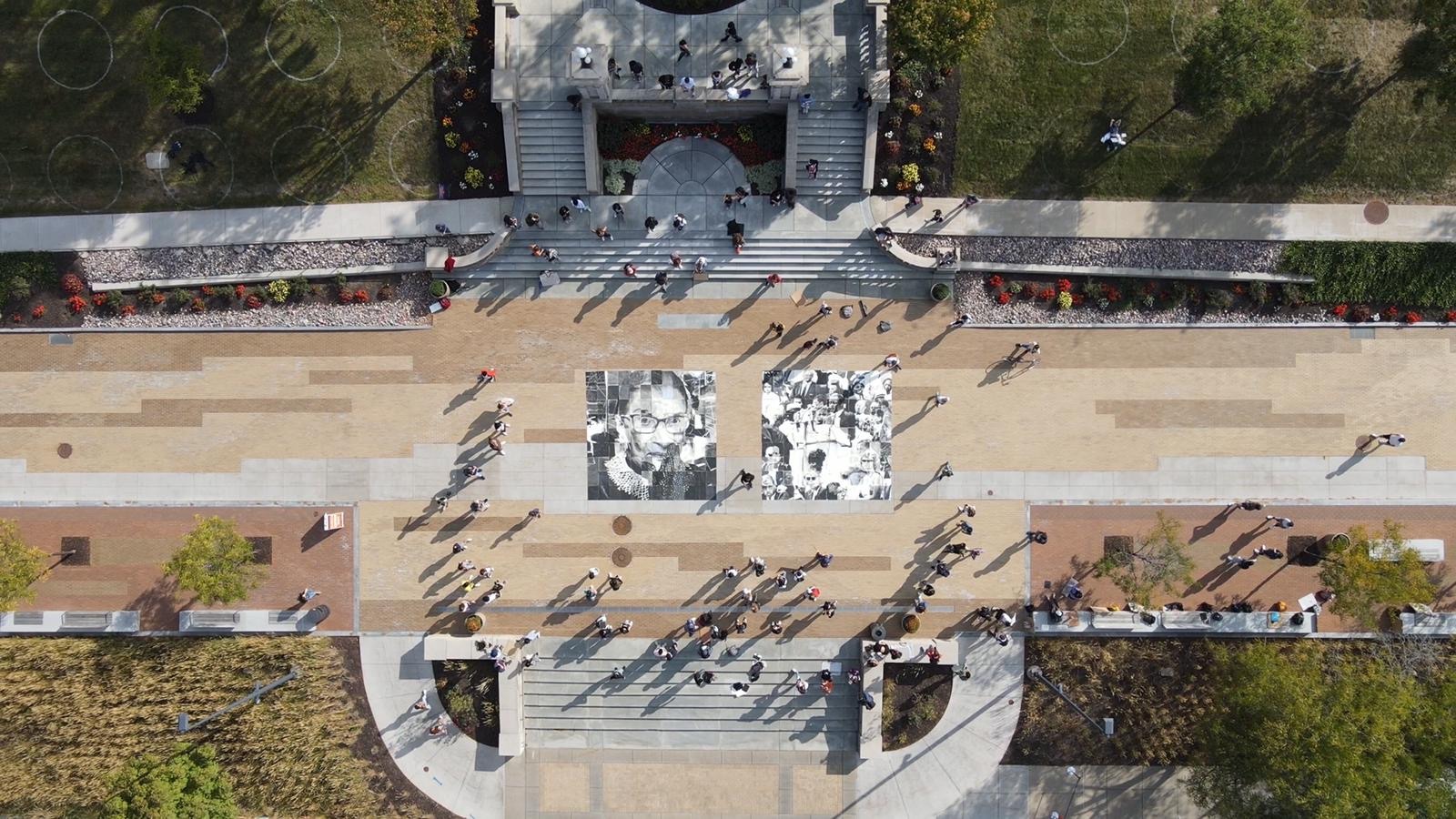 aerial photo of an art installation of Ruth Bader Ginsburg and John Lewis on a walking path