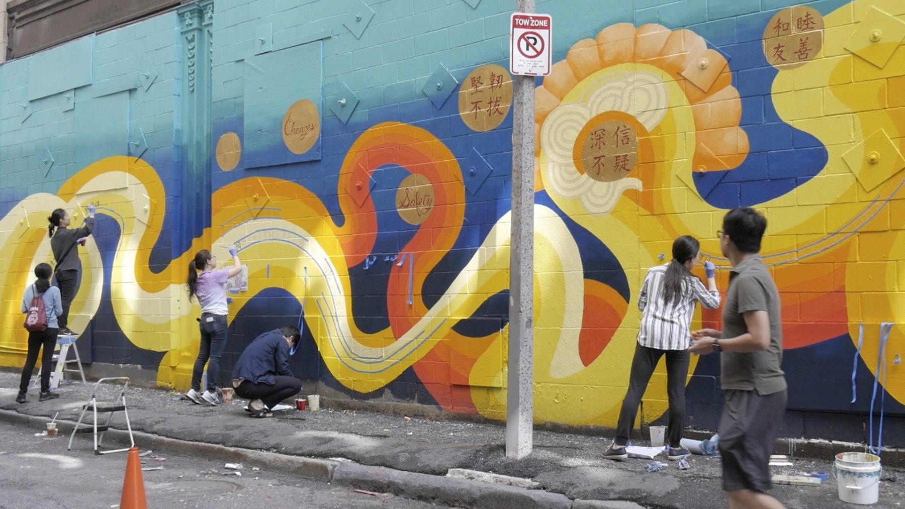 six volunteers pitch in on painting mural