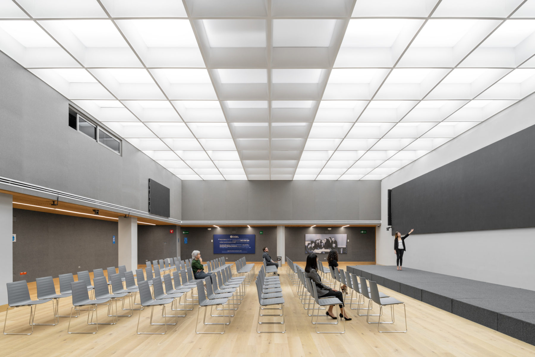 Interior photo of main meeting space. Chairs set up for presentation and a small stage at the front of the room