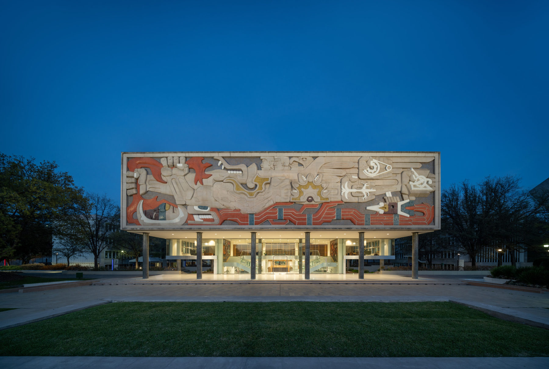 exterior photo of building at dusk. light illuminates the entry