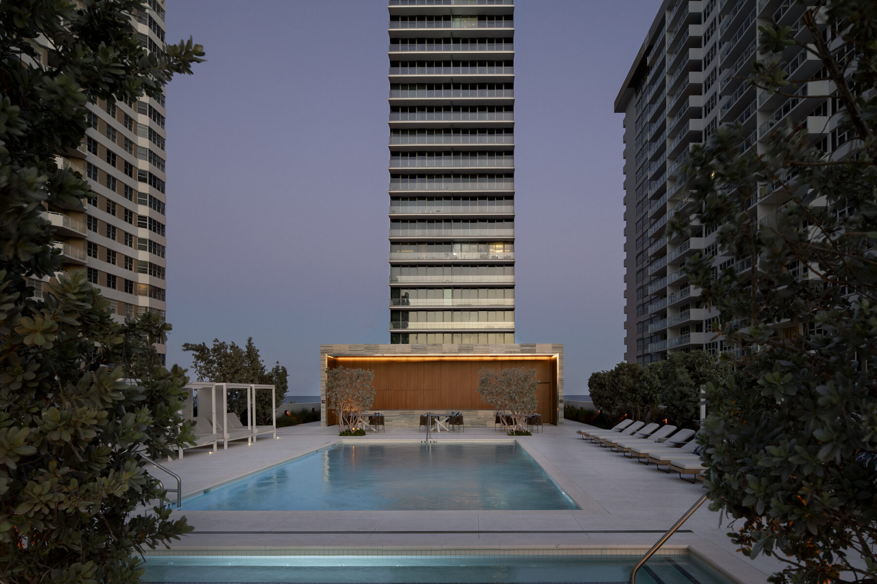 Perspective photograph of 2000 Ocean Hallandale showing west-side pool and urban lounge area