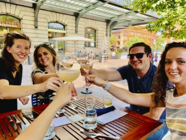 a group of people at a table toasting their drinks