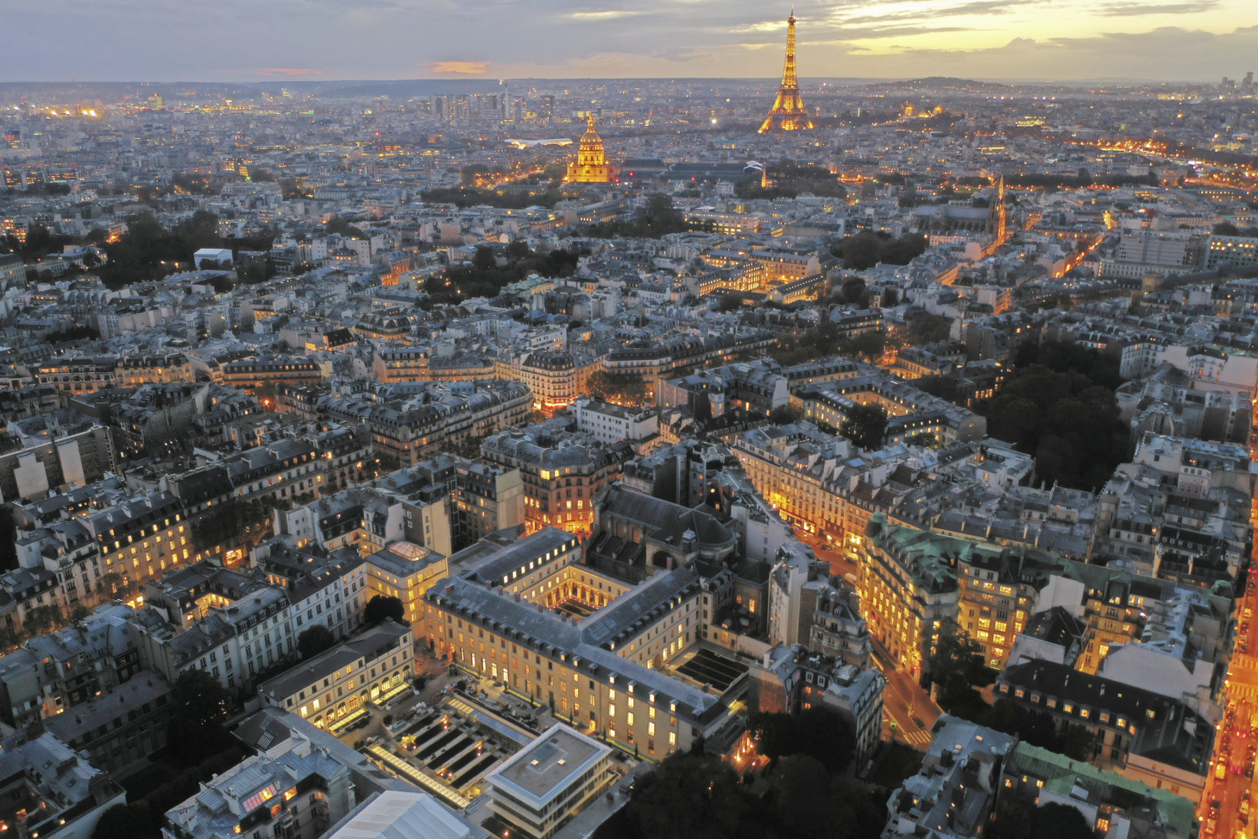 aerial photo of site at dusk, the Eiffel Tower is in the background