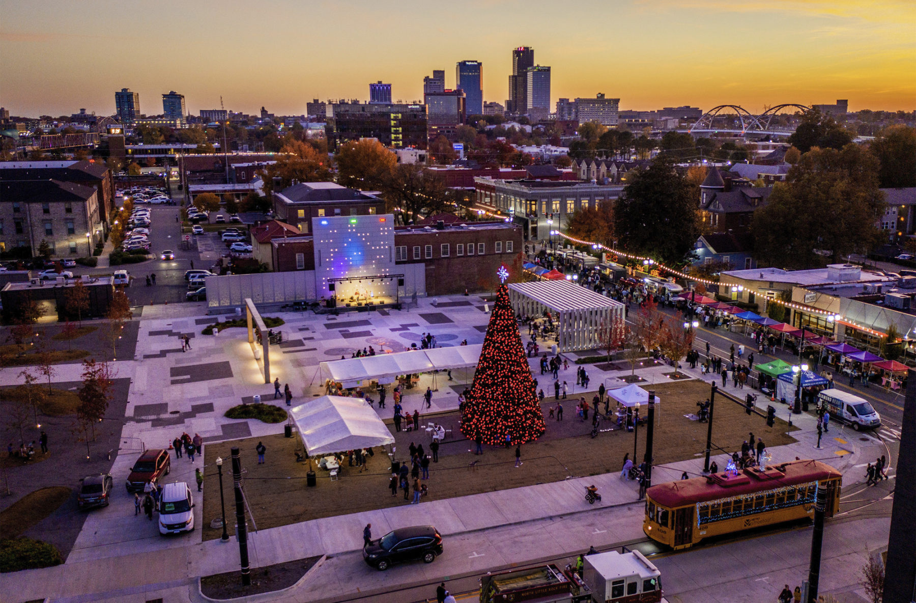 aerial photograph of plaza at dusk. a christmas tree is set up in the plaza