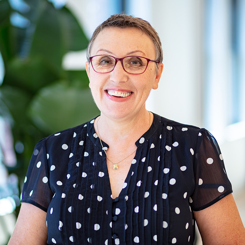 interior headshot in office space with plant in background