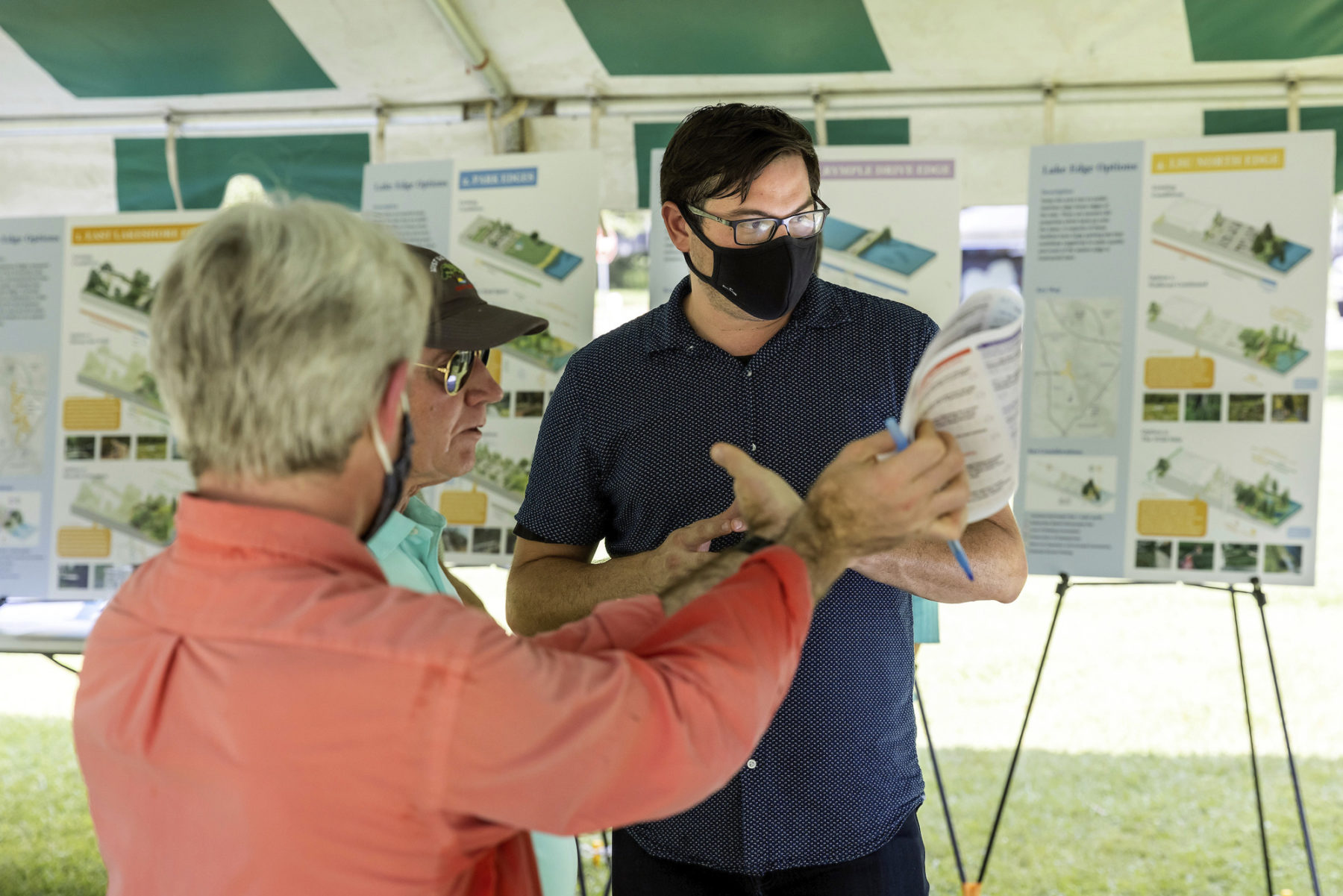 Joshua Brooks listening to two older people at an engagement event