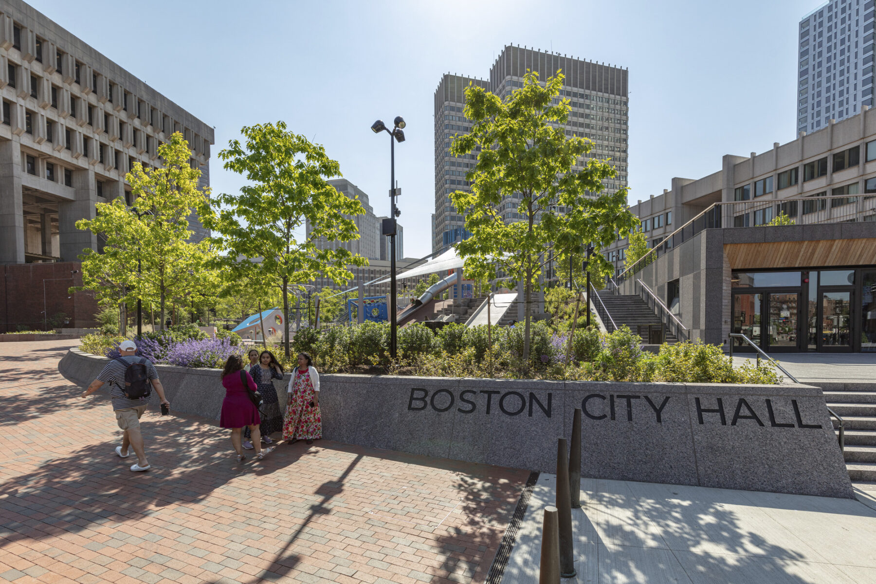 View of rampway into the plaza with stone wall engraved with 