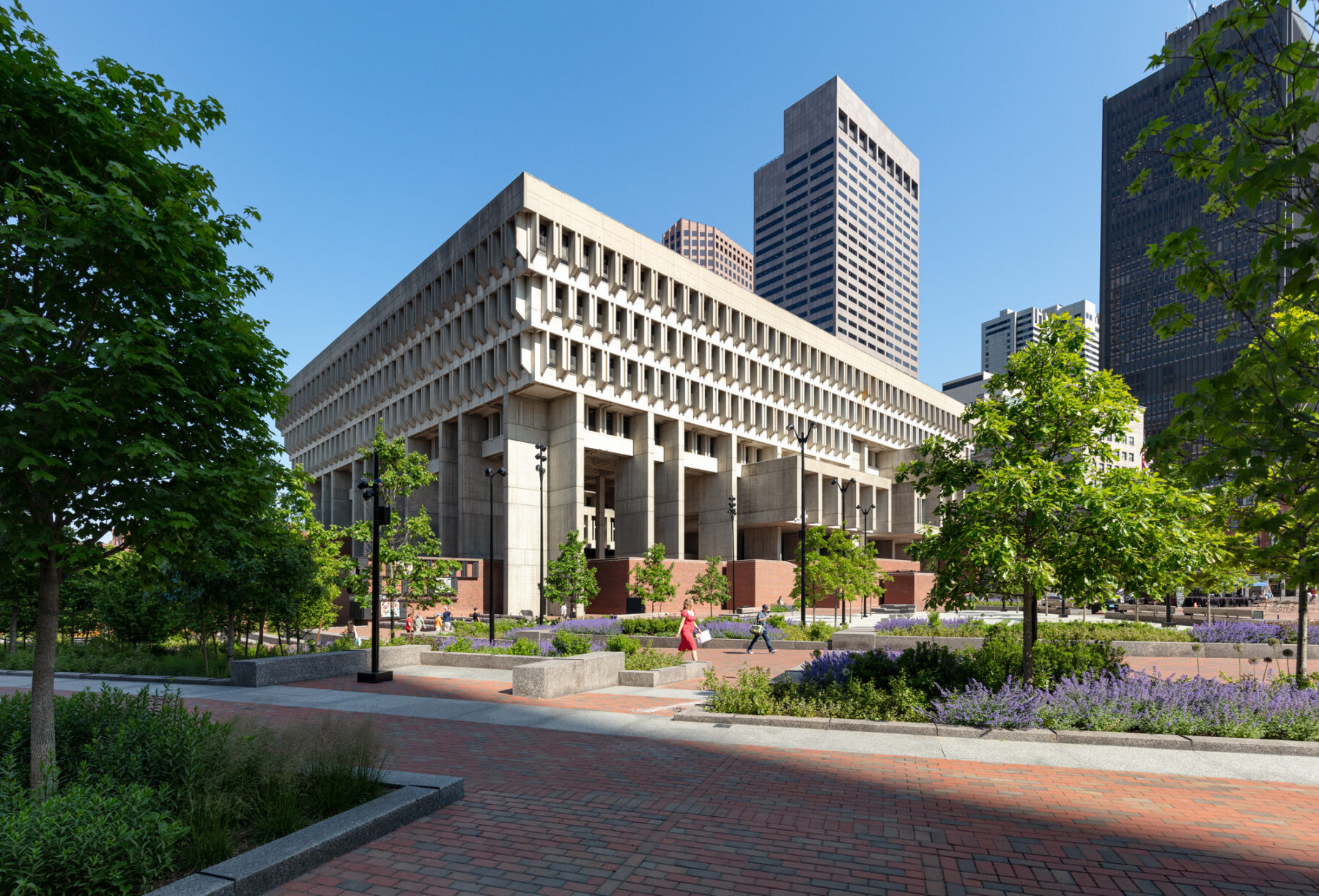 exterior photo of boston city hall plaza landscape with building in background, people walking through the space
