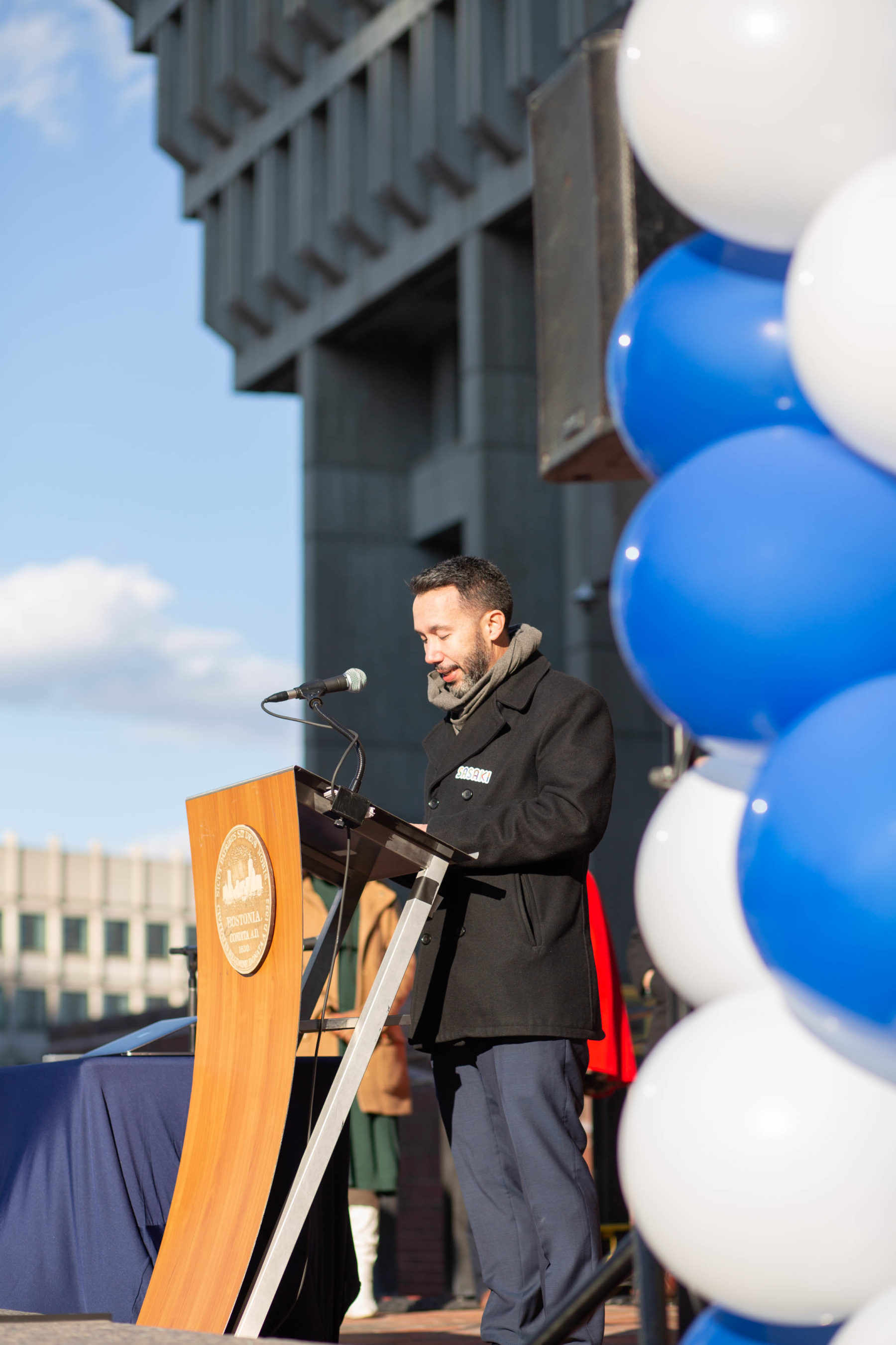 A man stands at the podium at the plaza's new speaker's corner