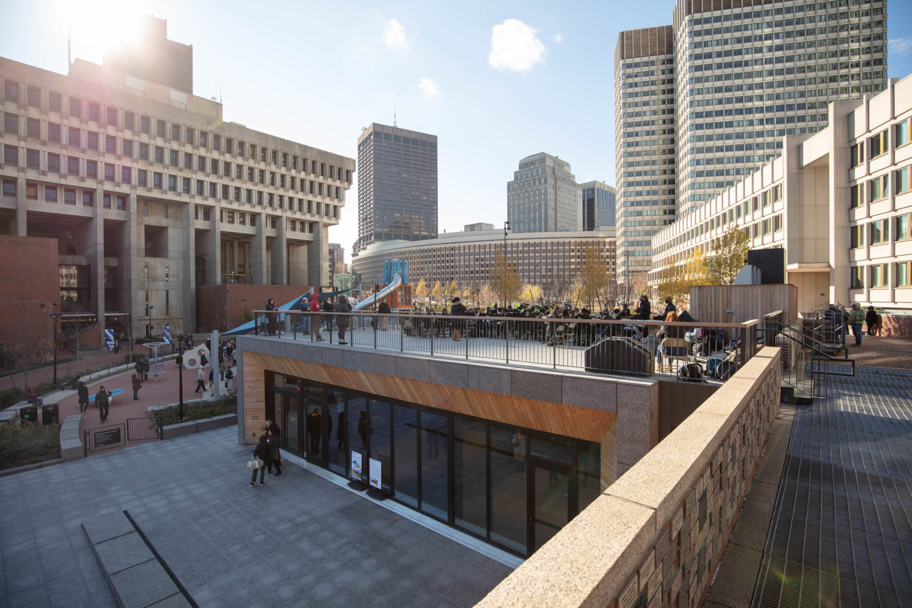 A group of musicians are performing atop the new pavilion, who's roof doubles as a performance space