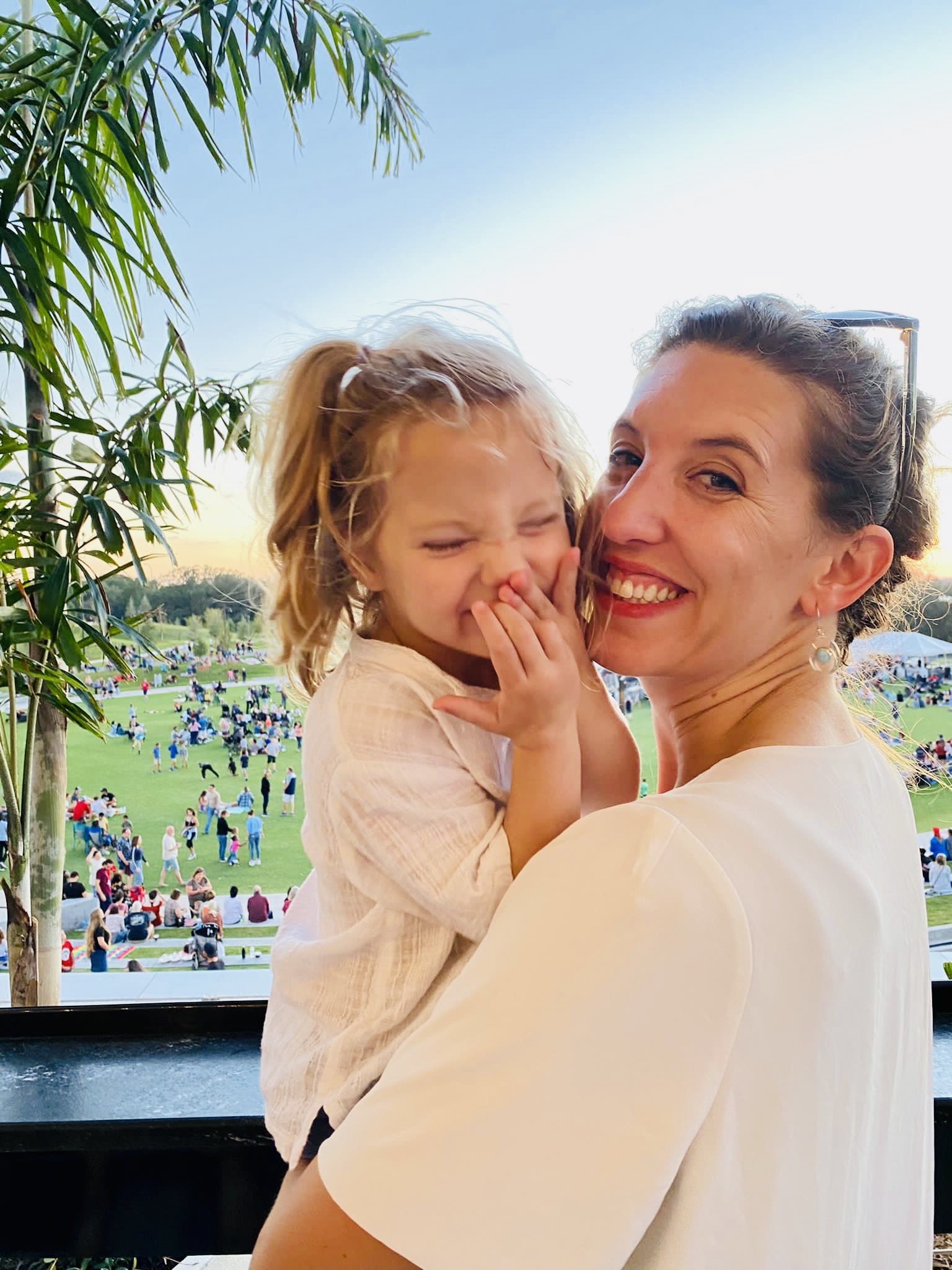 Anna smiling as she holds her daughter at Bonnet Springs Park