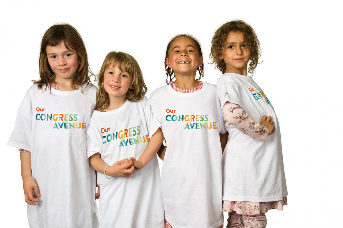 photo of four children wearing white t-shirts that say 
