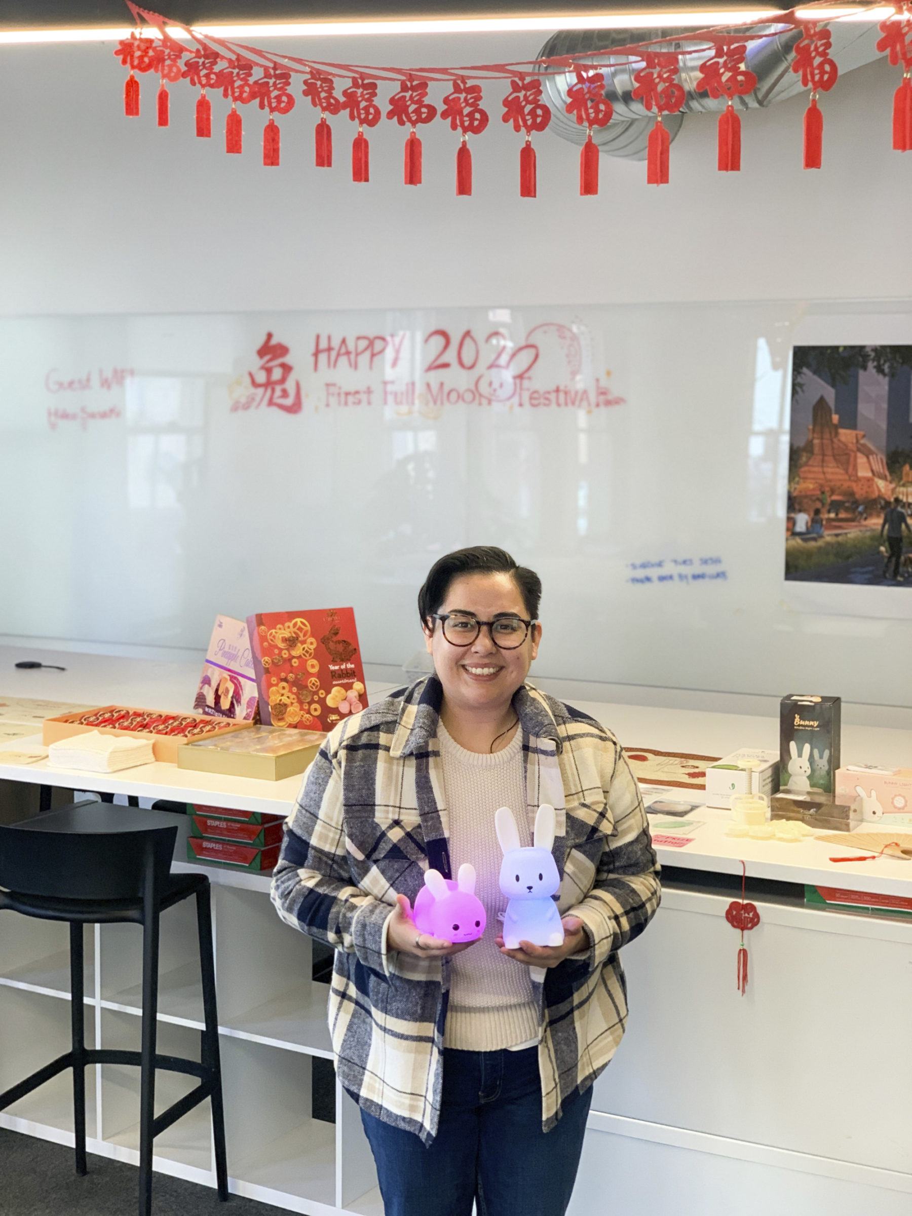 someone holding two glowing rabbit decorations