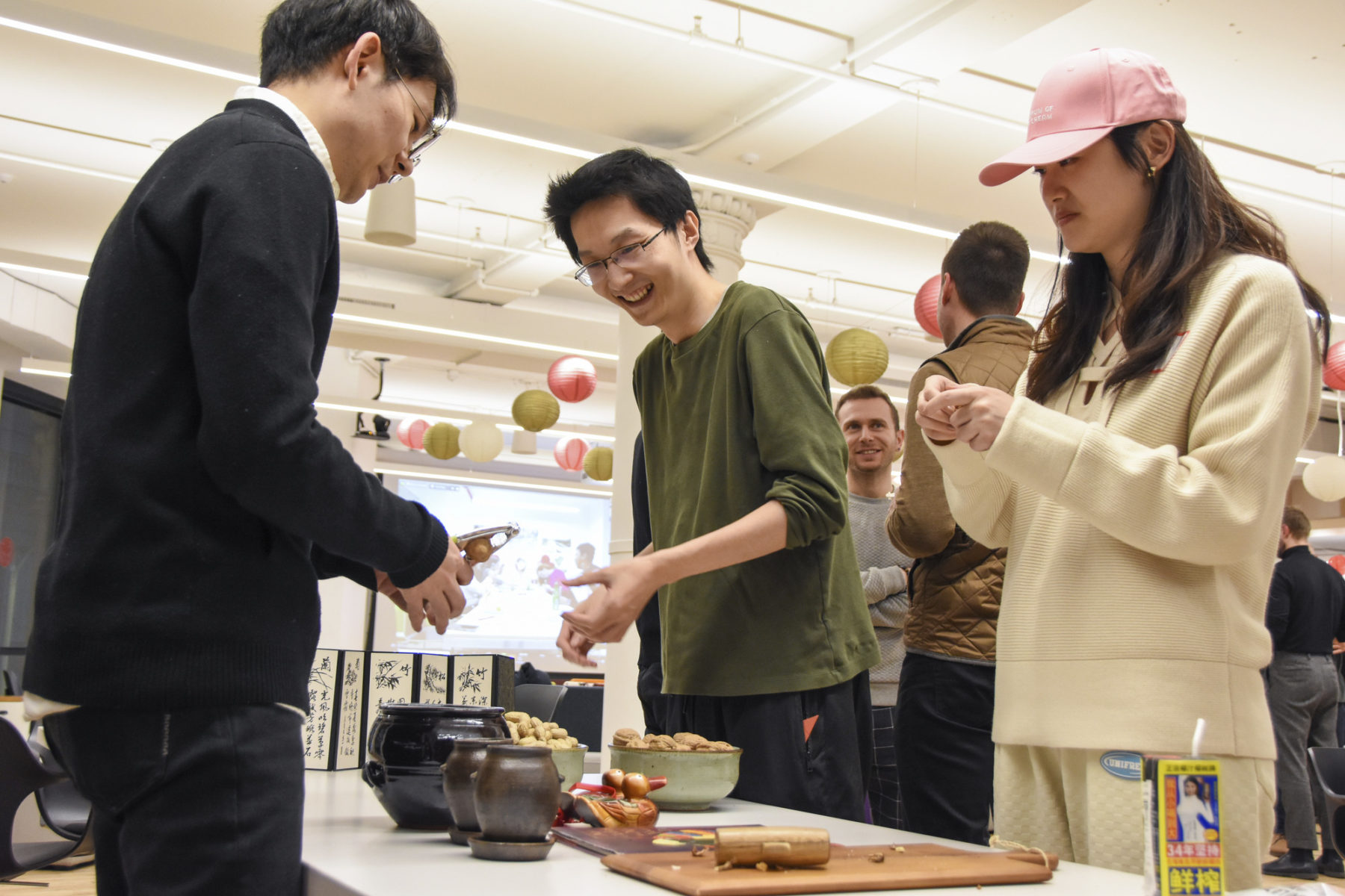 people crushing different kinds of nuts, a holiday tradition