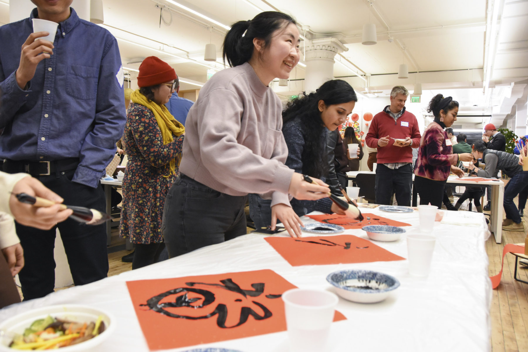 people painting the mandarin character for 