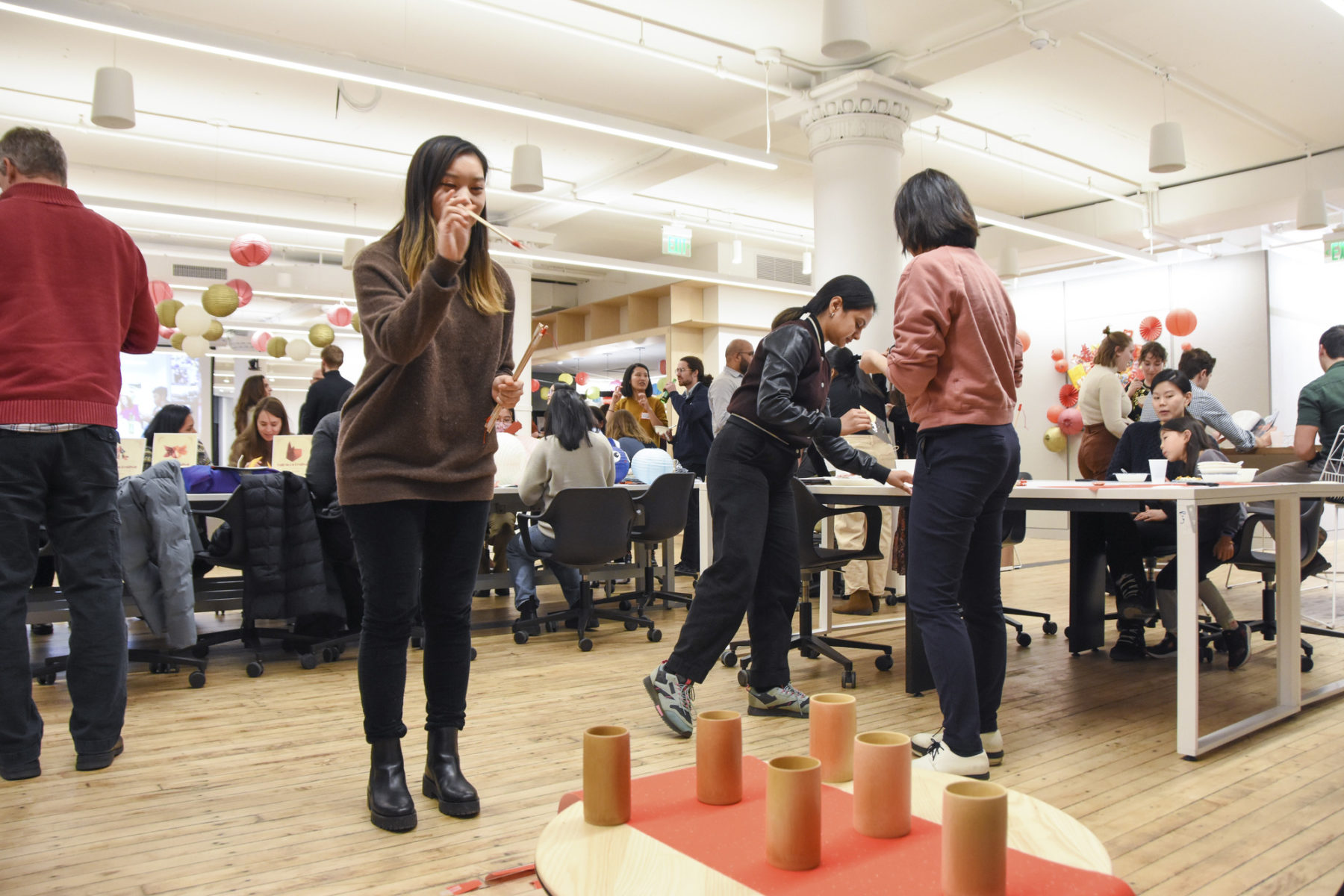 someone playing pitch pot by throwing a stick into a pot