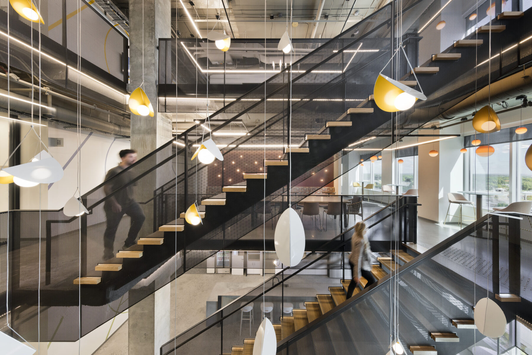 Dangling light fixtures hang in the middle of the central staircase