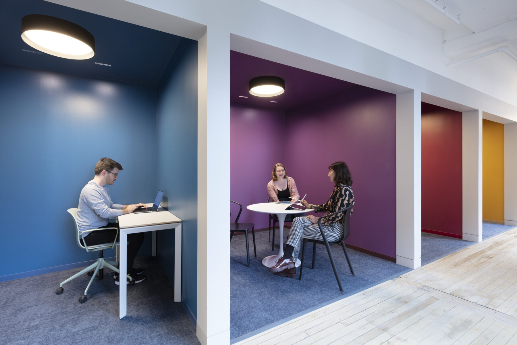 colorful nooks with seated individuals working and meeting