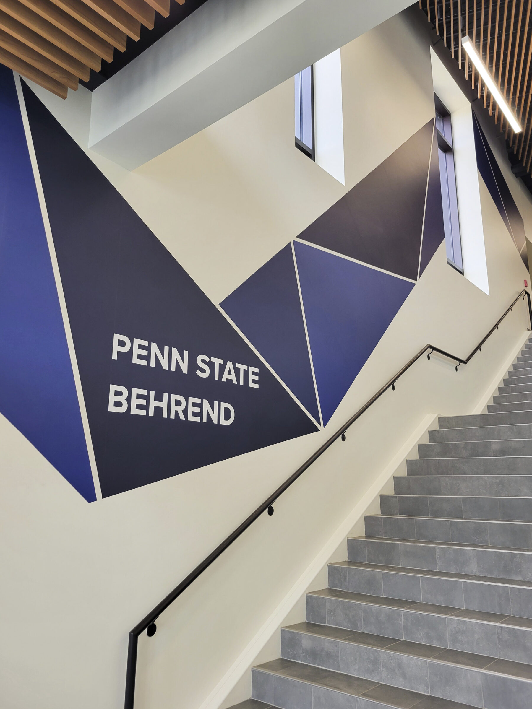 view of graphics on wall alongside stairs