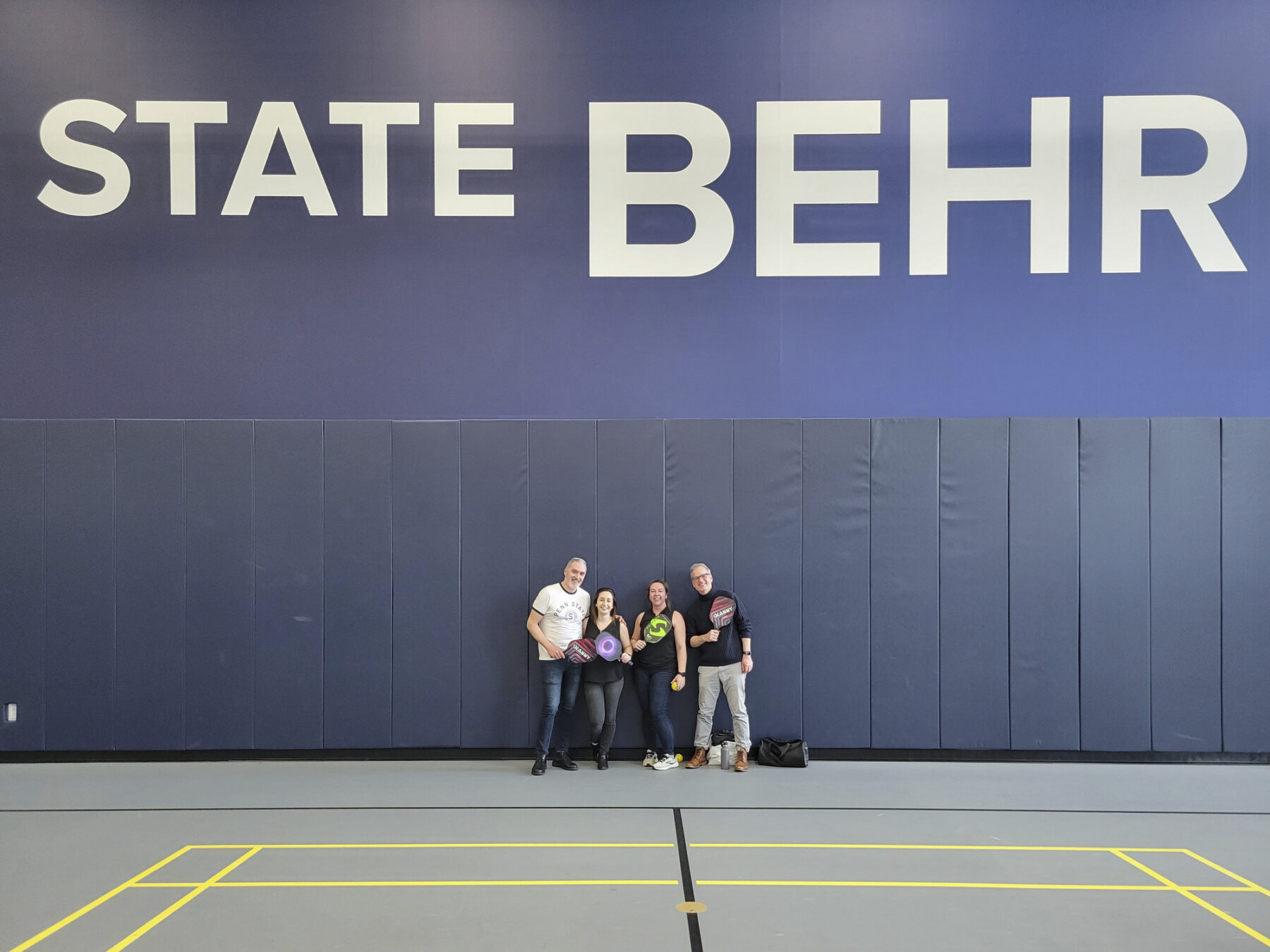 sasaki designers gathered, smiling, on the pickleball court