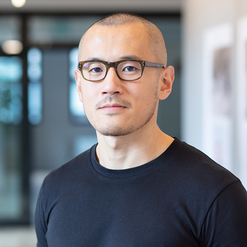 interior headshot of man in front of glass