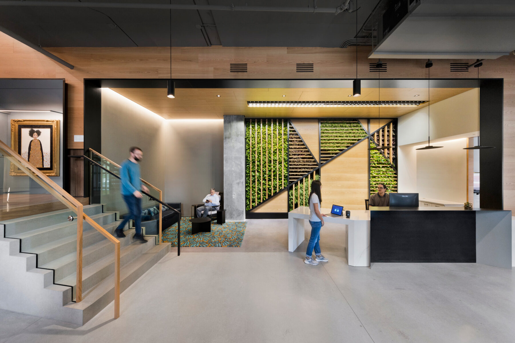 View of lobby and reception area with geometric patterned living plant wall behind