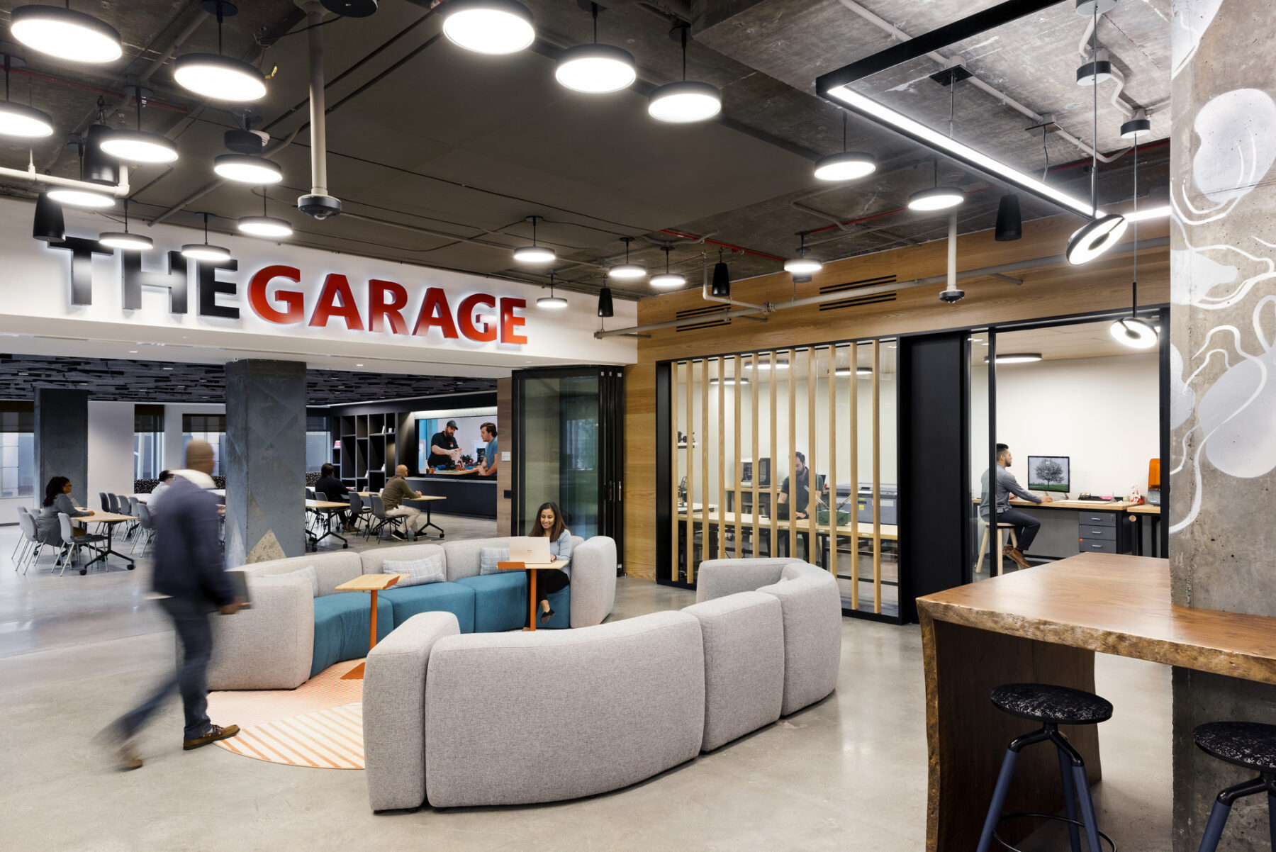 The Garage-Maker space with modular furniture and views into designated areas with machines and screens