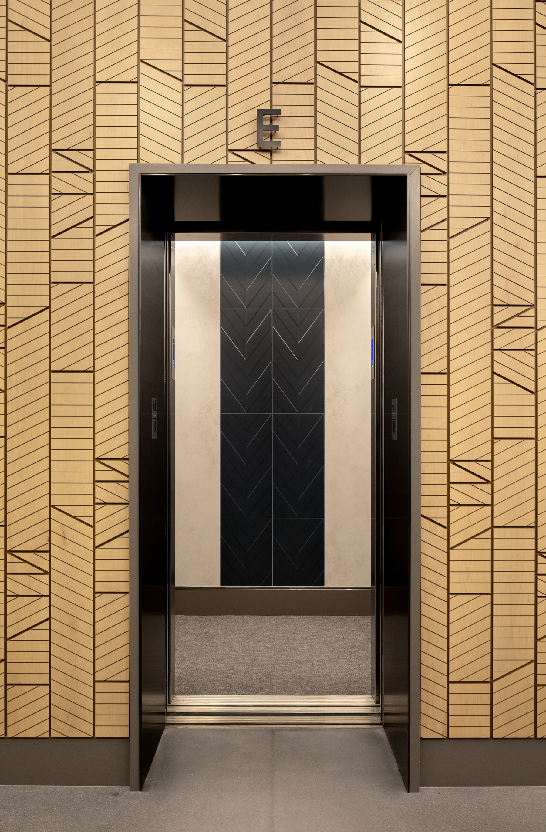 detail photograph of geometric wood panelling around elevator core