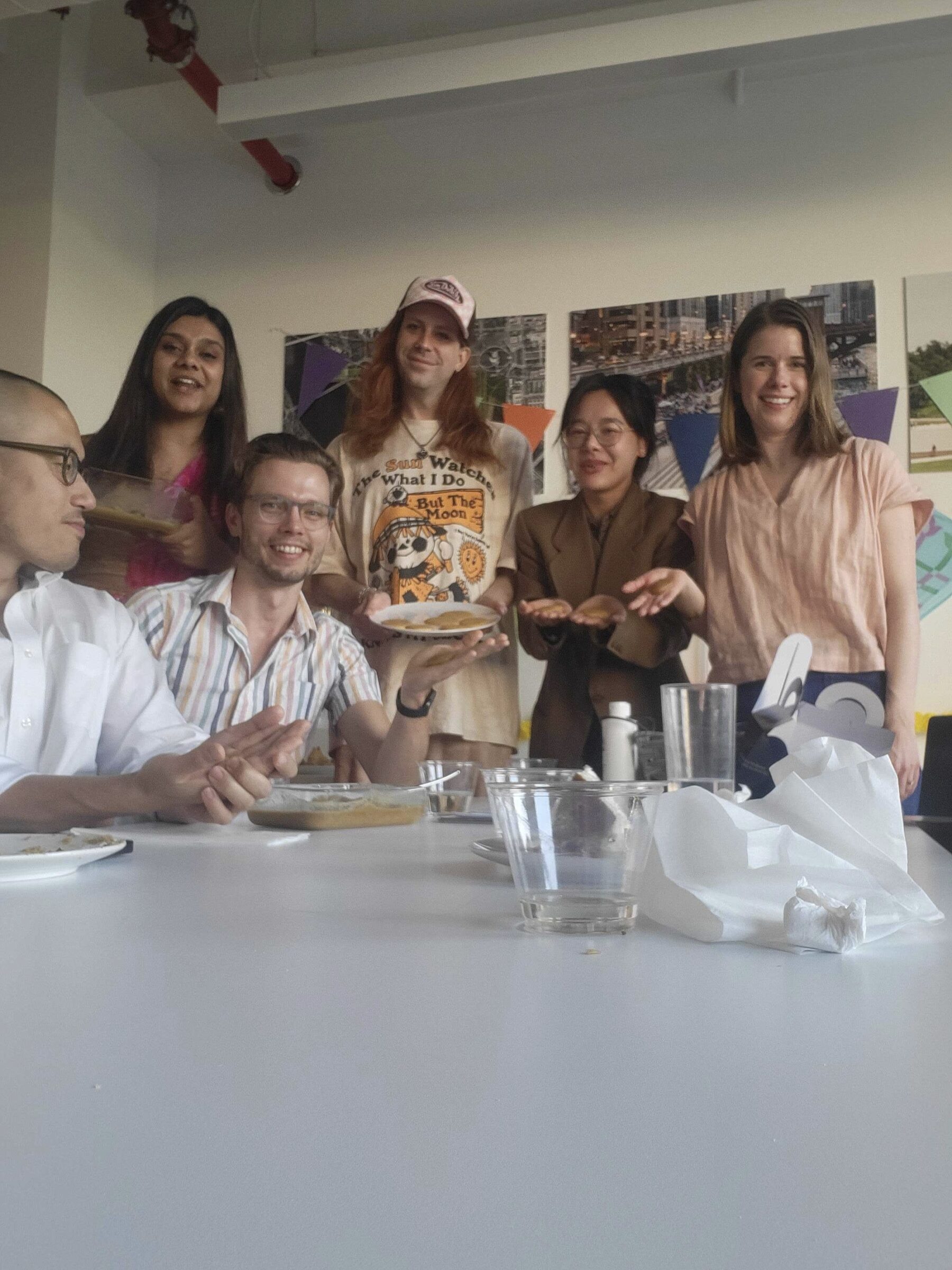 a photo of a group of people holding laddoo