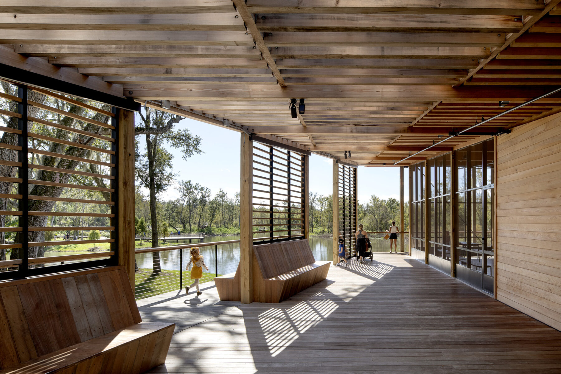 perspective photograph of boardwalk leading to the boathouse and lagoon