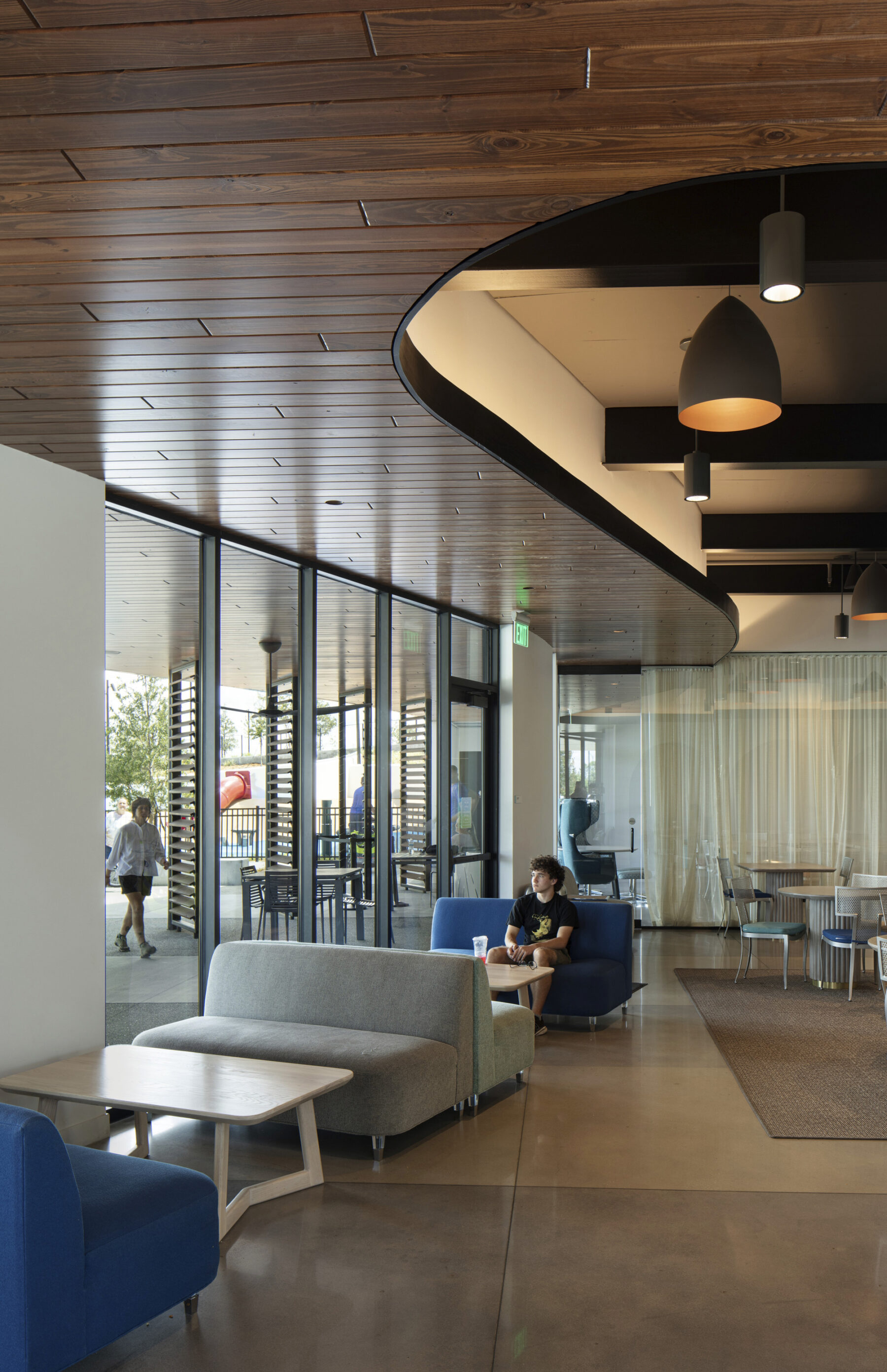 photograph of cafe in welcome center featuring young man sitting on lounge seating