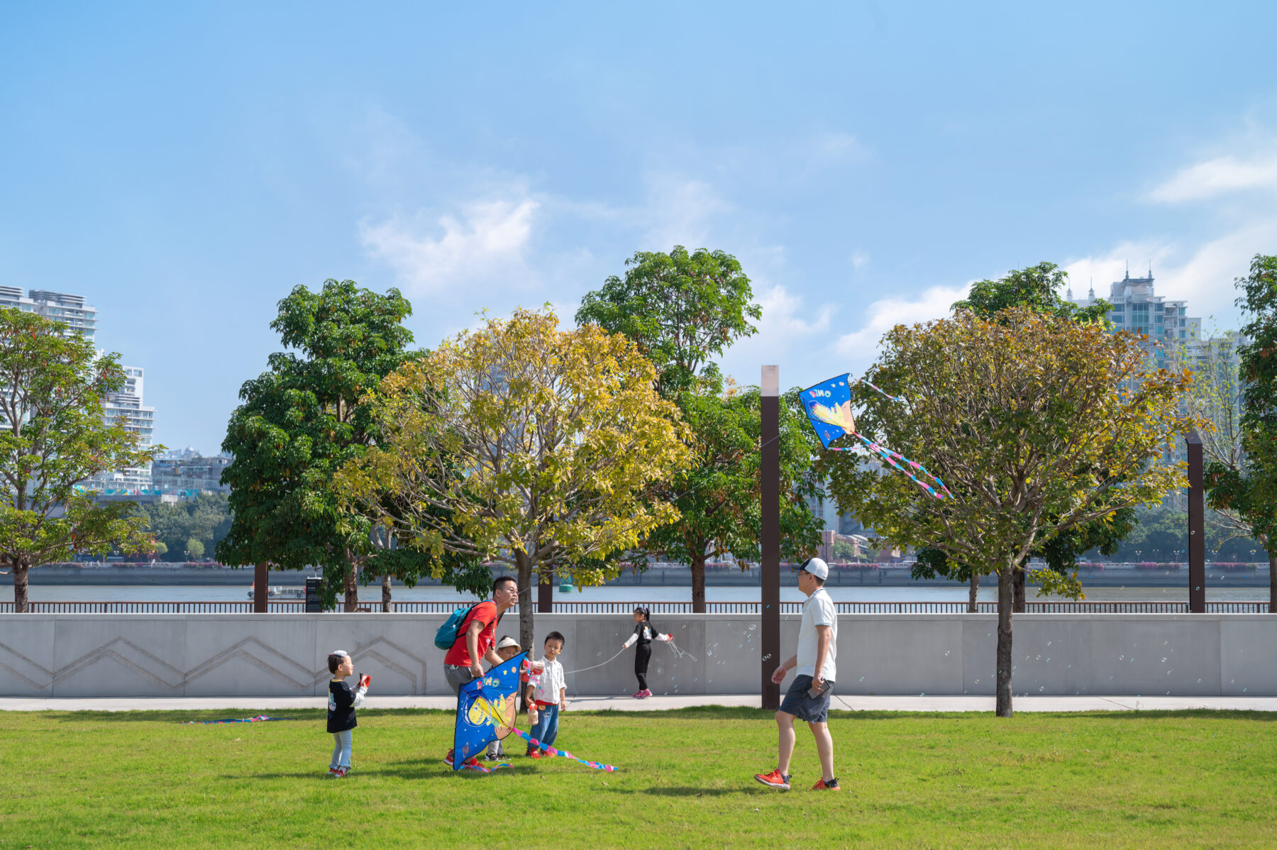 Photo of the event lawn with a small family playing with a kite