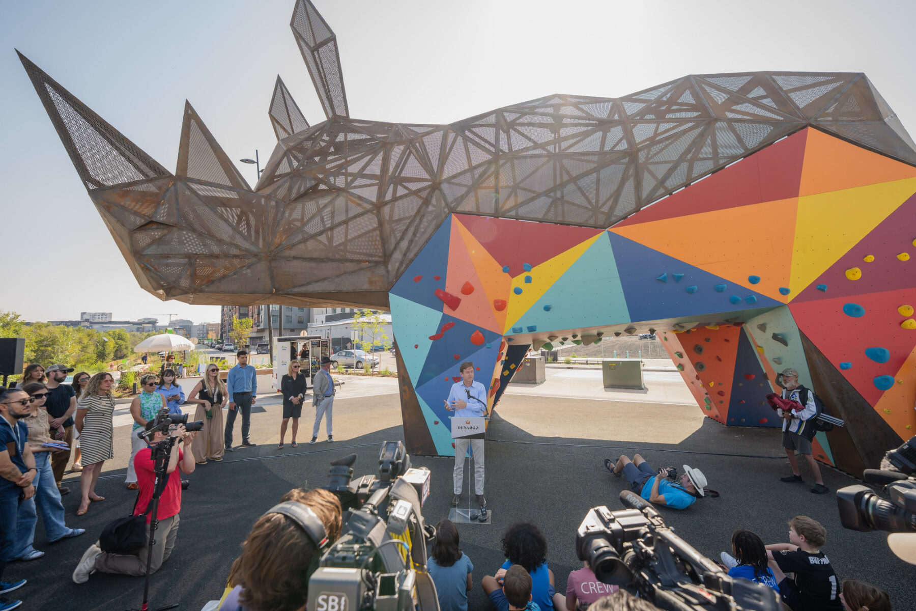 Photo of Rhingo the rhino, a custom fabricated climbing structure with colorful, geometric panels with hand and foot holds for bouldering activity