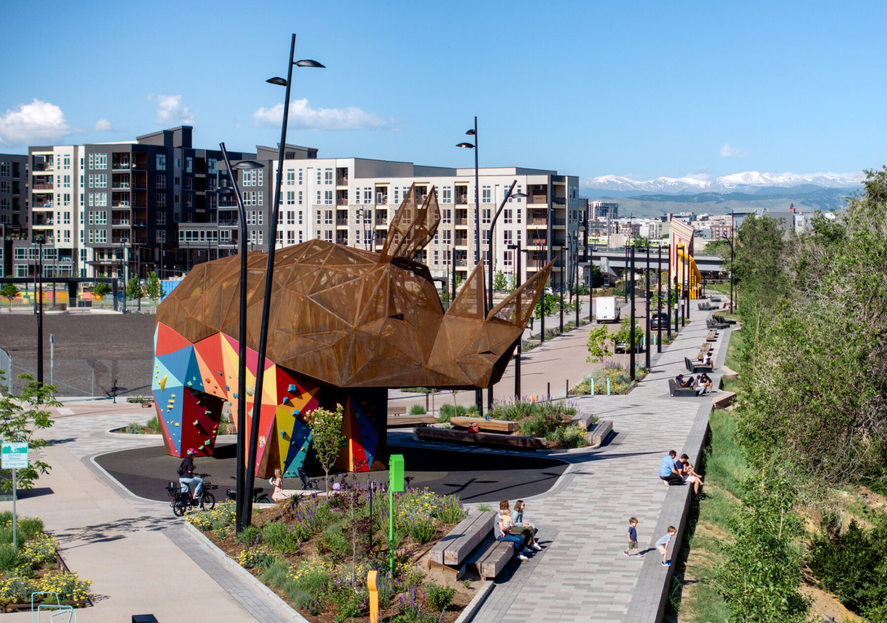 Aerial view of rhino and riverfront promenade with people sitting along the edge