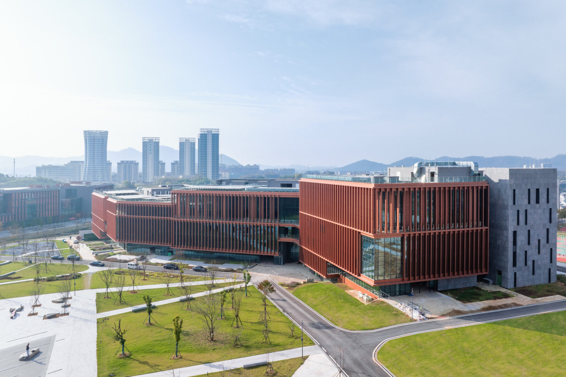 South Bay Campus Library building aerial photo with city skyscrapers in distance