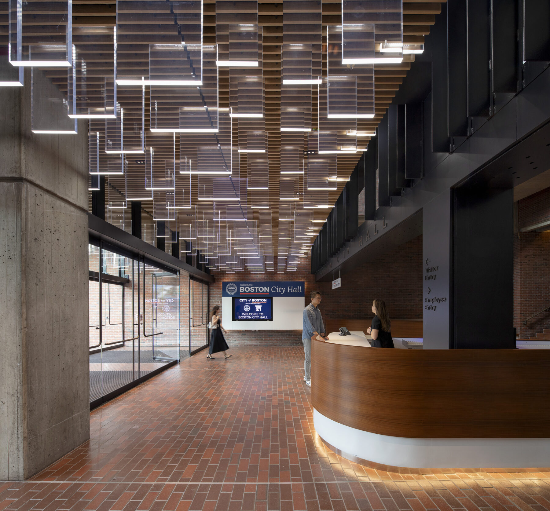 photograph of the interior of the north entrance to City Hall, featuring custom transparent light fixtures