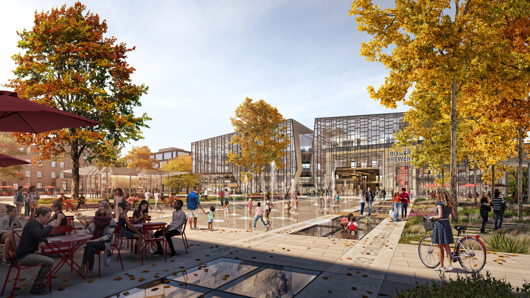 Rendering of the quad showing outdoor gather spaces in the autumn with colorful foliage, cafe seating, and pedestrians and cyclists