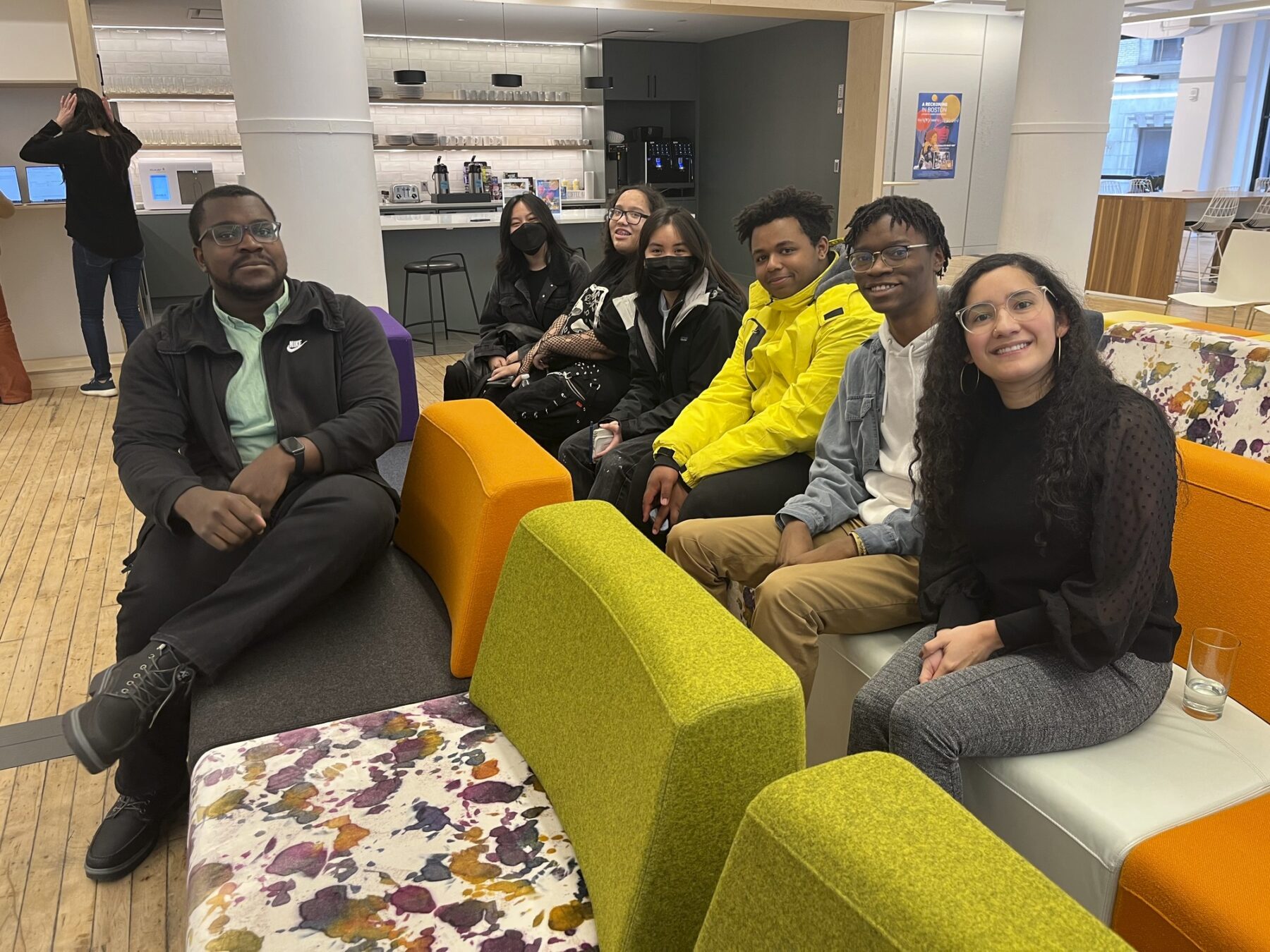 People sitting on colorful chairs smiling