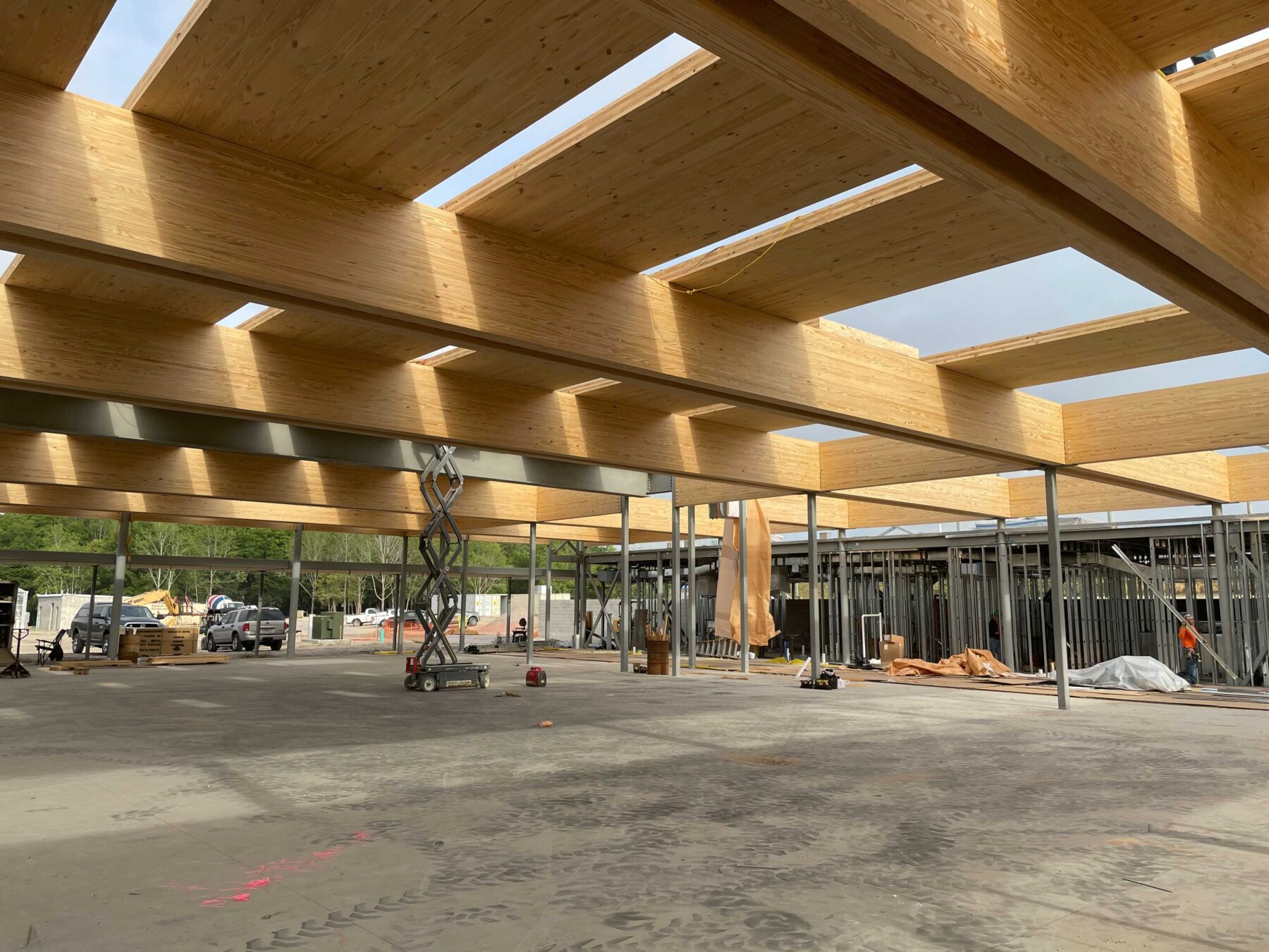 Eye-level shot of CLT panel installation over the ballroom’s glulam spans during construction of the Bonnet Springs Park Event Center